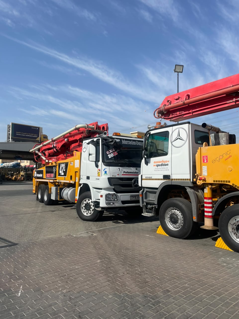 Putzmeister 42m and 63m concrete pumps parked in the Al Ruwayyah 3 truck market